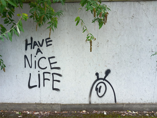 This is a photograph of graffiti that reads 'have a nice life'